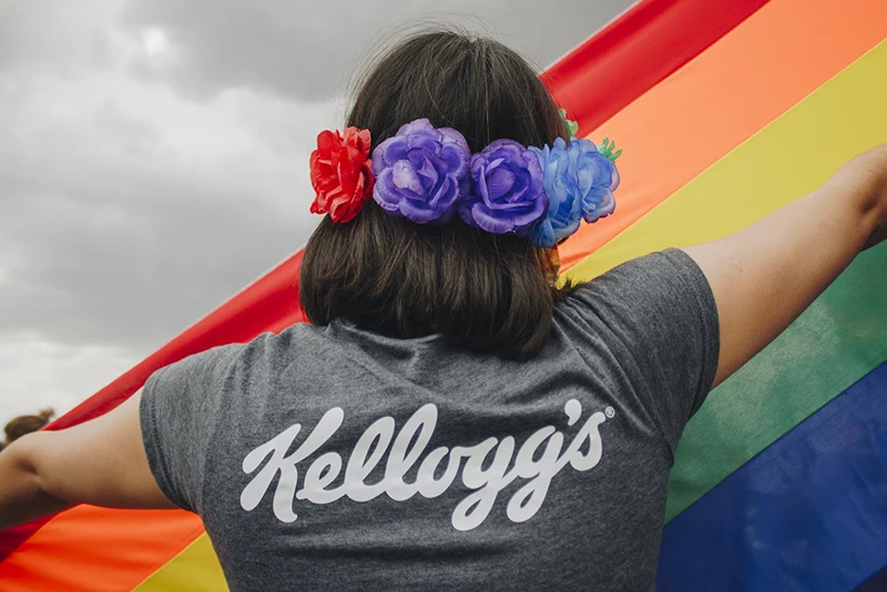 Pride Flag draped over employee's shoulders mobile