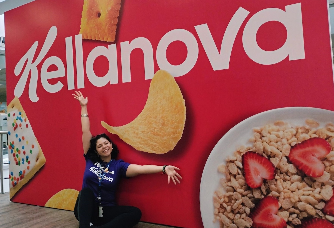 Kellanova Employee posing in front of Kellanova Wall